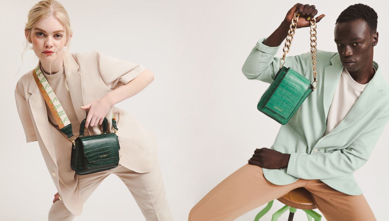 Split image of Penny wearing the Reader Satchel + Highway Strap in Forest Green, and Magbul holding the High Road Mini Emerald + Elemental Chain Strap in Gold.