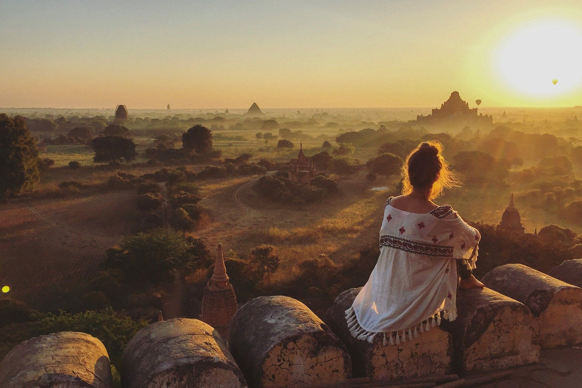 Taralynn Disher sitting watching a sunset