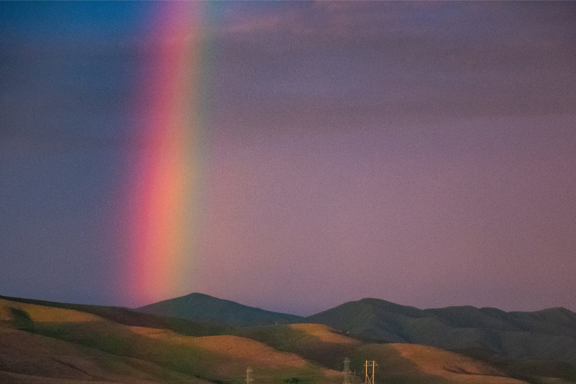 An image of a rainbow against a dark indigo sky