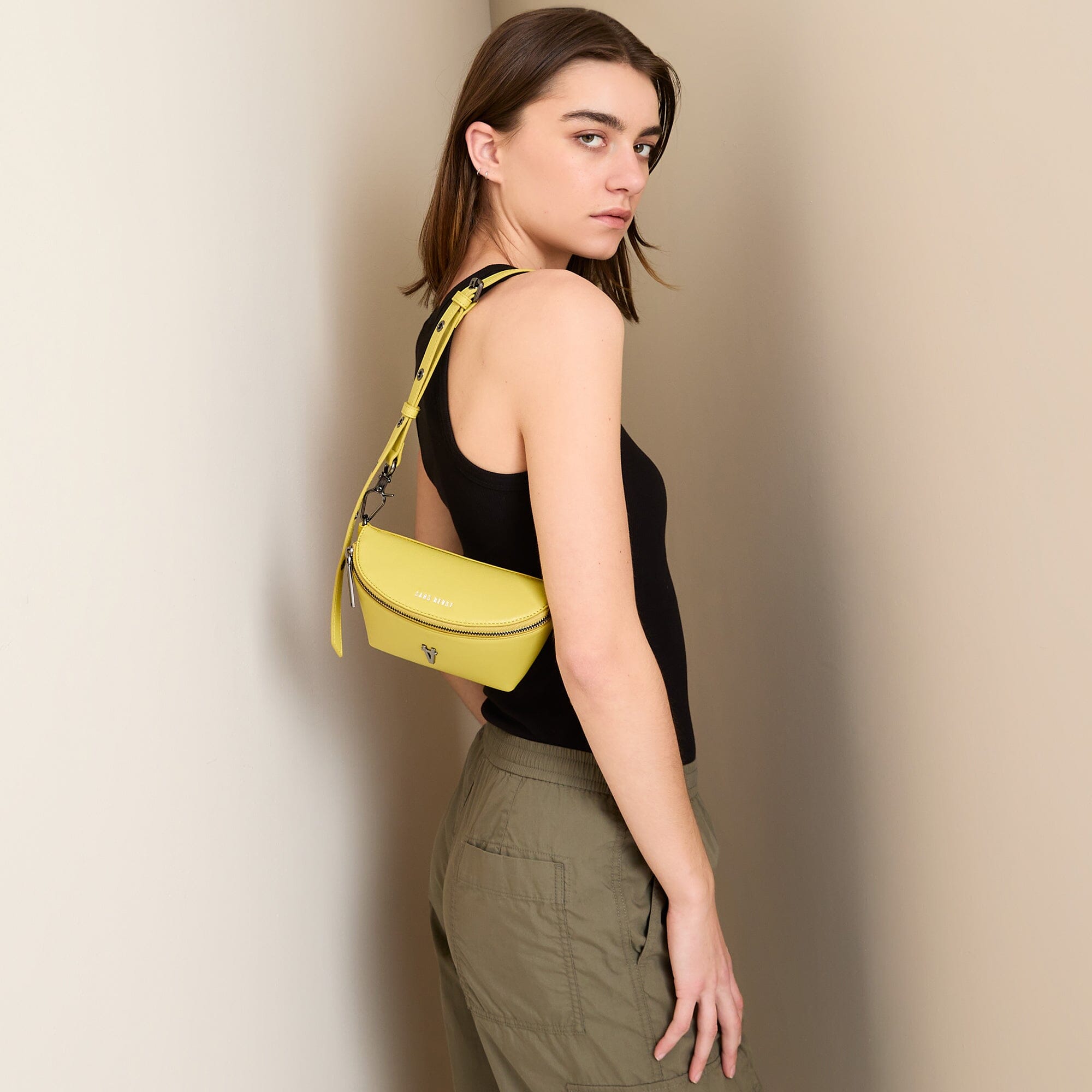 Tiny Spark Vegan Crossbody Bag Yellow worn on shoulder