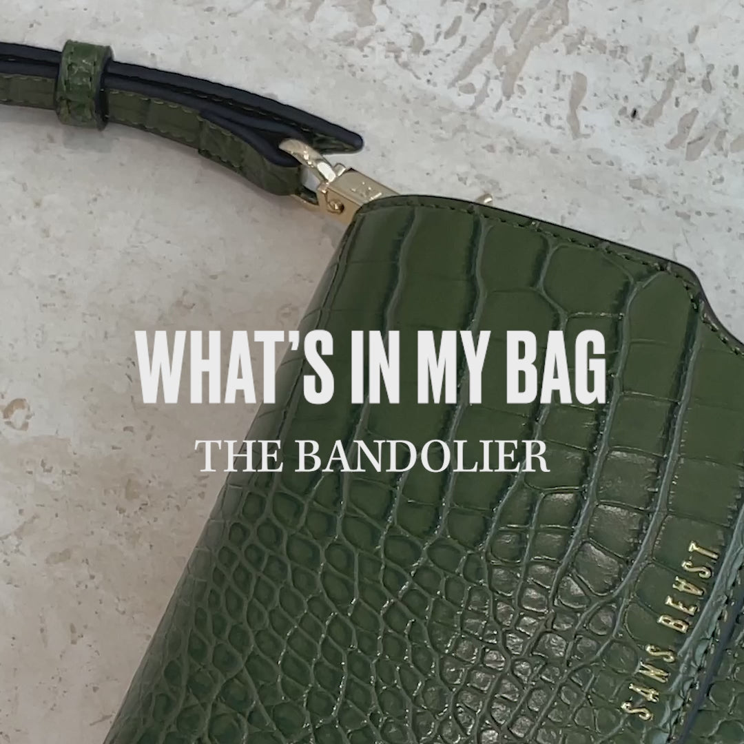 A video of the Olive Bandolier being packing with items such as a phone and wallet.