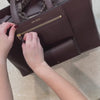 Sans Beast All Hours Vegan Leather Tote Burgundy being packed with various items.