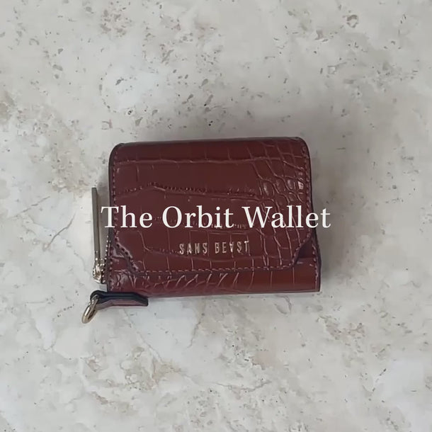 Video of the Sans Beast Orbit Vegan Leather Wallet being packed with various items.