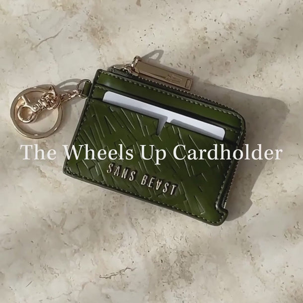 Video of the Sans Beast Wheels Up Vegan Leather Card Wallet packed with cards, notes + coins.