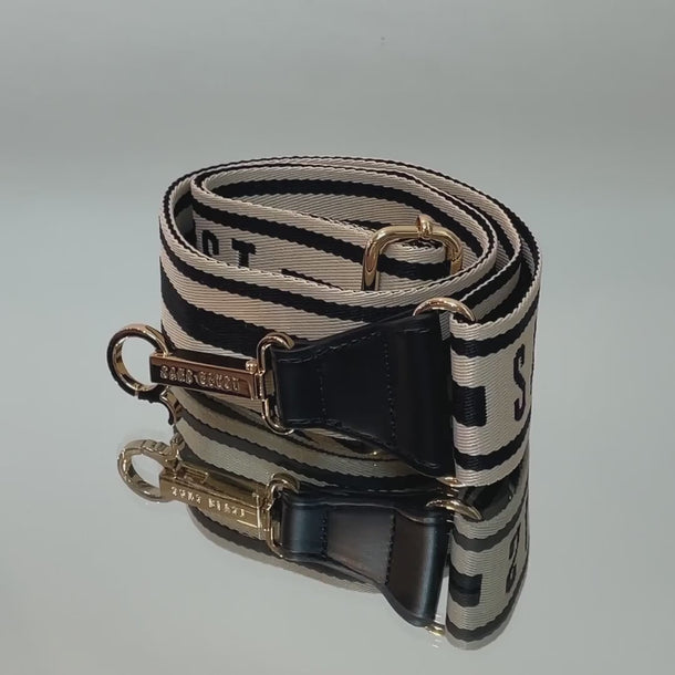 Video of a Sans Beast bag strap being clipped to a handbag.